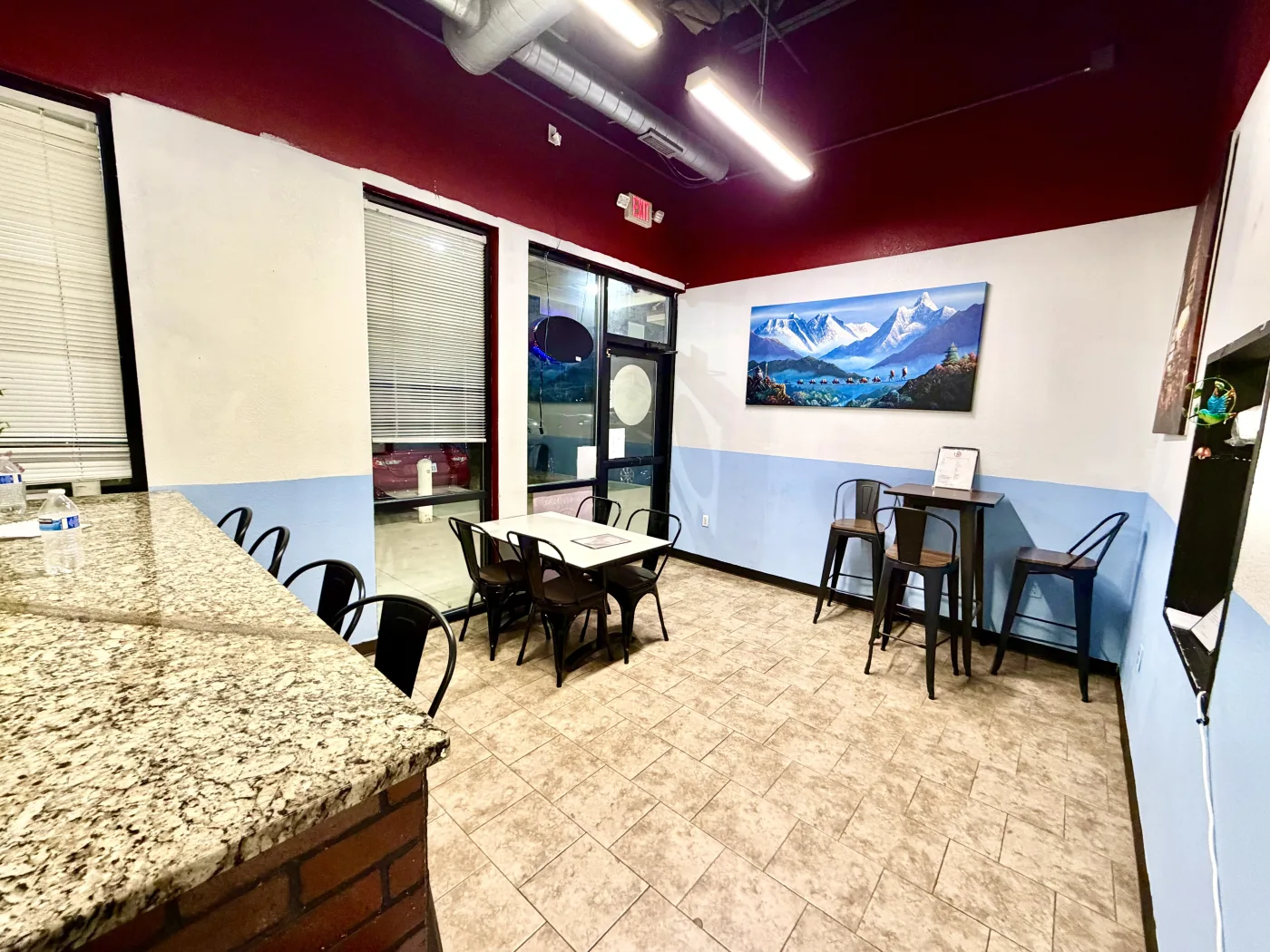 Interior seating area at Sagarmatha Momo with front windows and tables